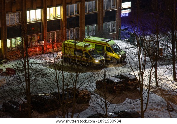 Two\
ambulance cars are waiting for a call. Ambulance in the night\
winter city. Calling a doctor at night. Health and medicine.\
Coronavirus. Russia, St. Petersburg January 10,\
2020