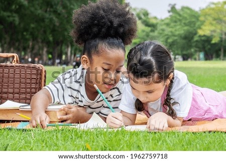 Similar – Two kids sitting on a bench and admiring the scenery