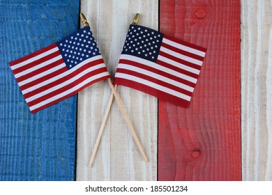 Two American Flags On A Red, White And Blue Painted Wood Surface. Perfect For Fourth Of July Or Memorial Day Projects.