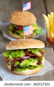 Two American hamburgers with fries in ketchup