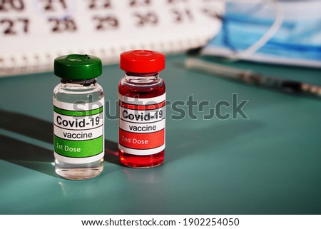 Two ampoules with doses from Covid. Two stages of vaccination. Vaccination. Copying a space.
