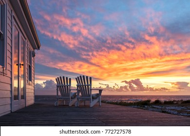 Two Ampty Chairs Facing Magficent Sunset View At Beach