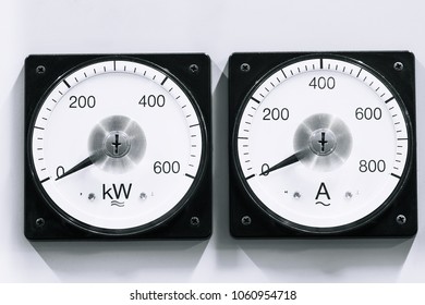 Two analog voltmeter & amp-meter on lights background.