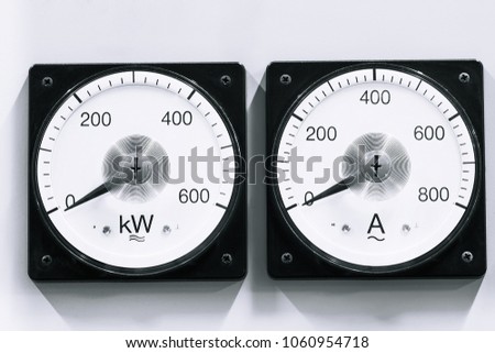 Two analog voltmeter & amp-meter on lights background.