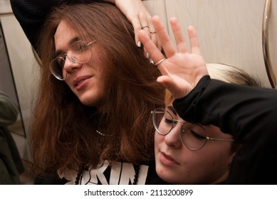 Two Androgynous Person Sitting Together And Enjoying One Another