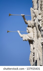 Two Angel Sculptures With Trumpet Horns On The Front Facade Of The Bass Performance Hall