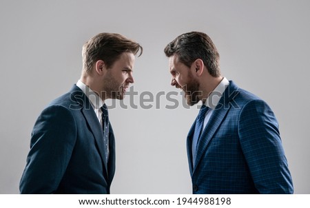 two angry businessmen shouting face to face arguing having struggle for leadership on businessmeeting have business competition, contradiction.