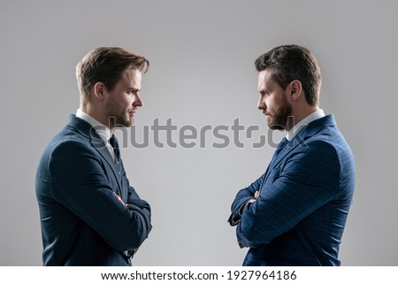 two angry businessmen standing face to face having struggle for leadership on businessmeeting because of business competition, business competition.
