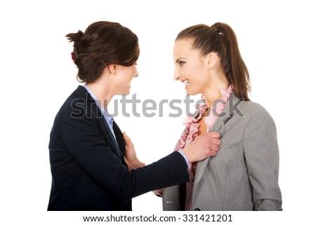 Two angry businesswomans arguing with eachother.