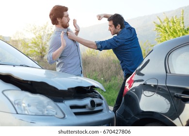 Two angry men arguing after a car fender-bender crash - Shutterstock ID 670427806