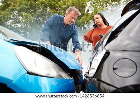 Two Angry Motorists Arguing Over Responsibility For Car Accident