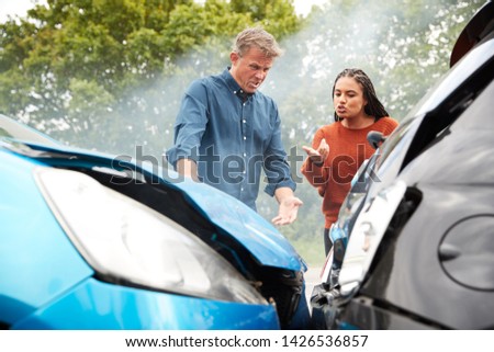 Two Angry Motorists Arguing Over Responsibility For Car Accident