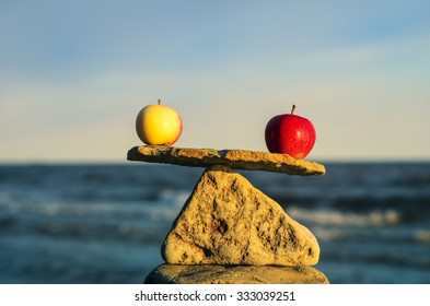 Two apples in balance on the top of stone - Shutterstock ID 333039251