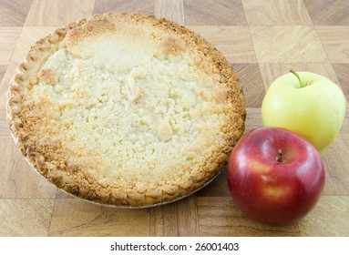 Two Apples Next To A Dutch Apple Pie