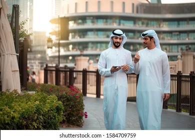 Two Arab Man Waering Traditional Clothes And Walking In Downtown 