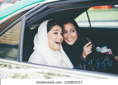 Two arabian girls spending time togehter outdoor making activities - Powered by Shutterstock