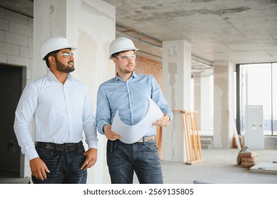 two architect engineers talking in a constructed office building.