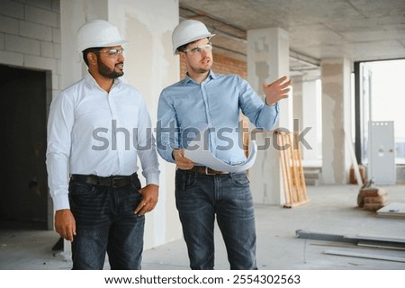 two architect engineers are walking in a constructed office building. implementation of the project.