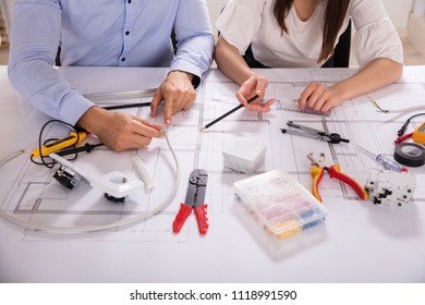 Two Architect Working With Work Tools Over Blueprint