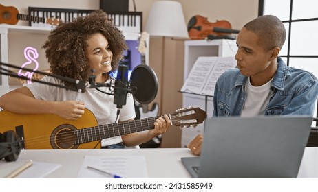 Two artists playing classic melody on classical guitar, singing smiling with laptop in music studio, a blend of classic and digital - Powered by Shutterstock