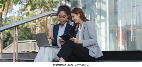 Two asia business women in conversation walking together on city street. Corporate colleagues workmate discussing new project while going to work. business outdoor. - Shutterstock ID 2249309163