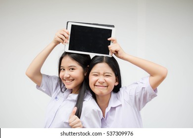 Two Asia Thai High School Student Uniform Best Friends Beautiful Girl Using Her Tablet And Funny
