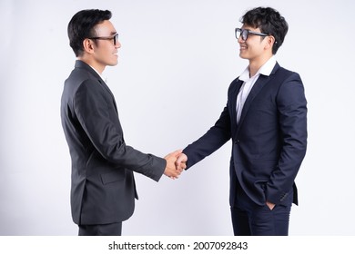 Two Asian Business Men Shaking Hands On A White Background
