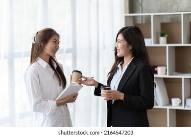 Two Asian Business Woman, Talking, Advising Each Other In Office, Training Team People Speaking Explaining Strategy At Marketing Workshop Concept.