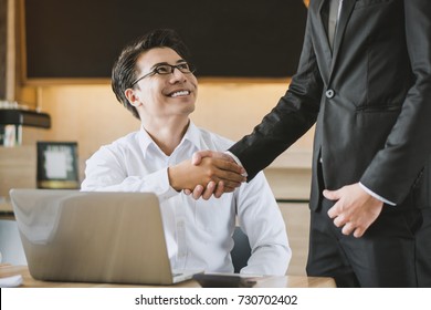 Two asian businessmen shaking hands in the meeting, Business partnership concept.