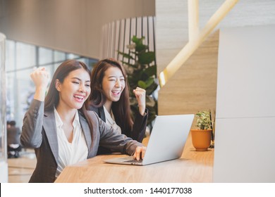 Two Asian Businesswoman In Suit Happy Working With Laptop At Modern Office