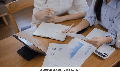 Two Asian businesswomen with friends and discussed their ideas at a meeting, Businesswoman talking with financial statement report together  at the office. - Shutterstock ID 2365414629