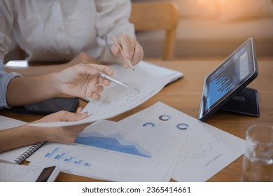 Two Asian businesswomen with friends and discussed their ideas at a meeting, Businesswoman talking with financial statement report together  at the office. - Shutterstock ID 2365414661