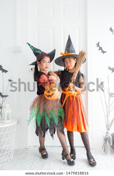 Two Asian Children Witch Costume Celebrating Stock Photo
