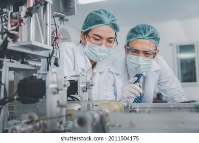 Two Asian doctor or engineer working at clean medical mask production factory, Production hygiene medical manufacturing qaulity inspection concept - Shutterstock ID 2011504175