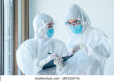 Two asian doctor wearing personal protective equipment or PPE working on quarantine patient infected coronavirus (covid-19), Teamwork medical staff during the epidemic crisis coronavirus.