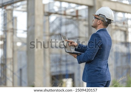 Two Asian engineer working at site of a large building project,Work overtime at construction site,Team of engineer discus at site,The architect, supervisor, and foreman meet to discuss the design