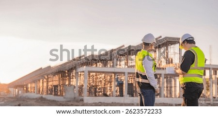 Two Asian engineer working at site of a large building project,Thailand people,Work overtime at construction site,Team of engineer discus at site