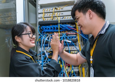 Two asian engineers working in the server room,Check the connection problems of computer networks,Thailand people