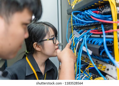 Two asian engineers working in the server room,Check the connection problems of computer networks,Thailand people
