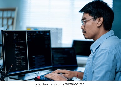 Two Asian female software developers collaborate closely while reviewing programming code and discussing technical project details in a professional IT office. The image highlights teamwork, communication, software engineering, coding, knowledge sharing, application development, and women working together in the technology industry.
