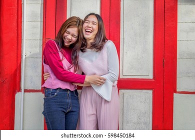 Two Asian Friends In Vintage Pink Dress Feels Happy.