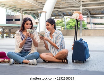 Two Asian Girl Happy Emotional Holding Money While Traveling In The City. Windfall,fortune,rich