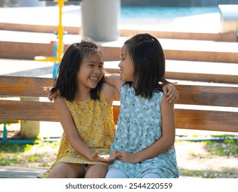 Two Asian girls hug each other with love in a park. - Powered by Shutterstock