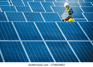 Two Asian male engineering teams are about to install solar panels. At the solar power generating station Asian engineering team ordered and installed solar cells - Shutterstock ID 1734053852