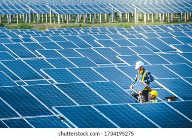 Two Asian male engineering teams are about to install solar panels. At the solar power generating station Asian engineering team ordered and installed solar cells - Shutterstock ID 1734195275