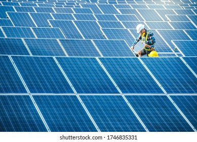Two Asian male engineering teams are about to install solar panels. At the solar power generating station Asian engineering team ordered and installed solar cells - Shutterstock ID 1746835331