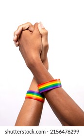 Two Asian man holding hands with a rainbow-patterned wristband on their wrists on white background. lgbt, same-sex relationships and homosexual concept