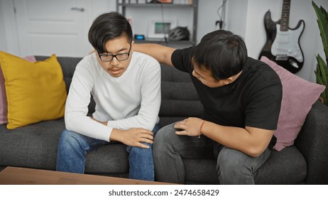 Two asian men relaxing and interacting in a modern living room, exuding a casual and friendly atmosphere. - Powered by Shutterstock