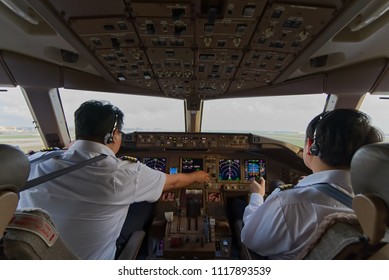 Two Asian Pilots In Airplane Cockpit Were Operating The Airplane. Captain Performing Pilot Monitor Duty Was Requested To Retract Landing Gear To Up Position By Co-pilot Who Performing Pilot Fly Duty.