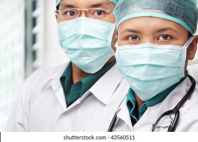 Two Asian Surgeon Posing To Camera With Protective Gear